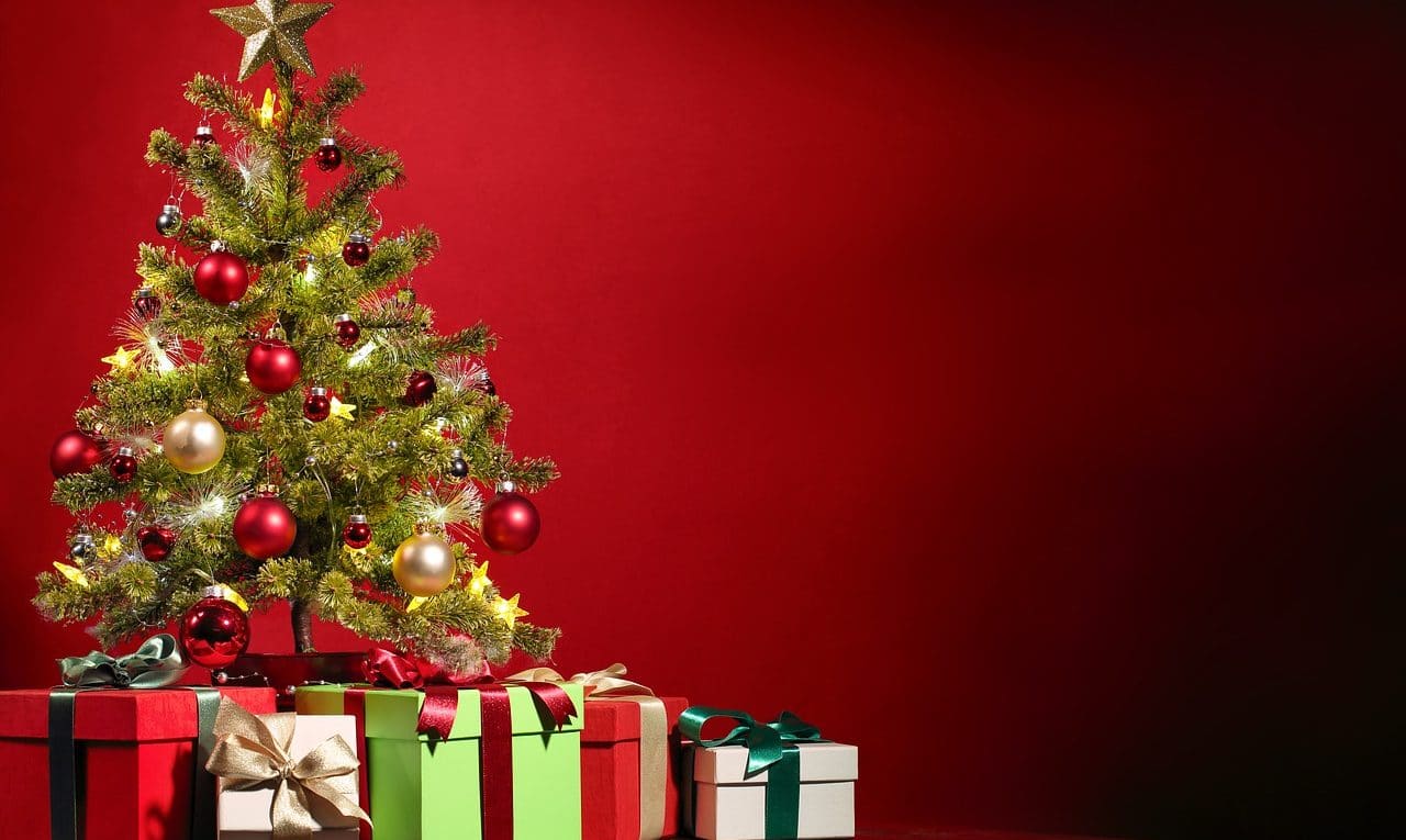 Wrapped Christmas gifts beside festive decorations